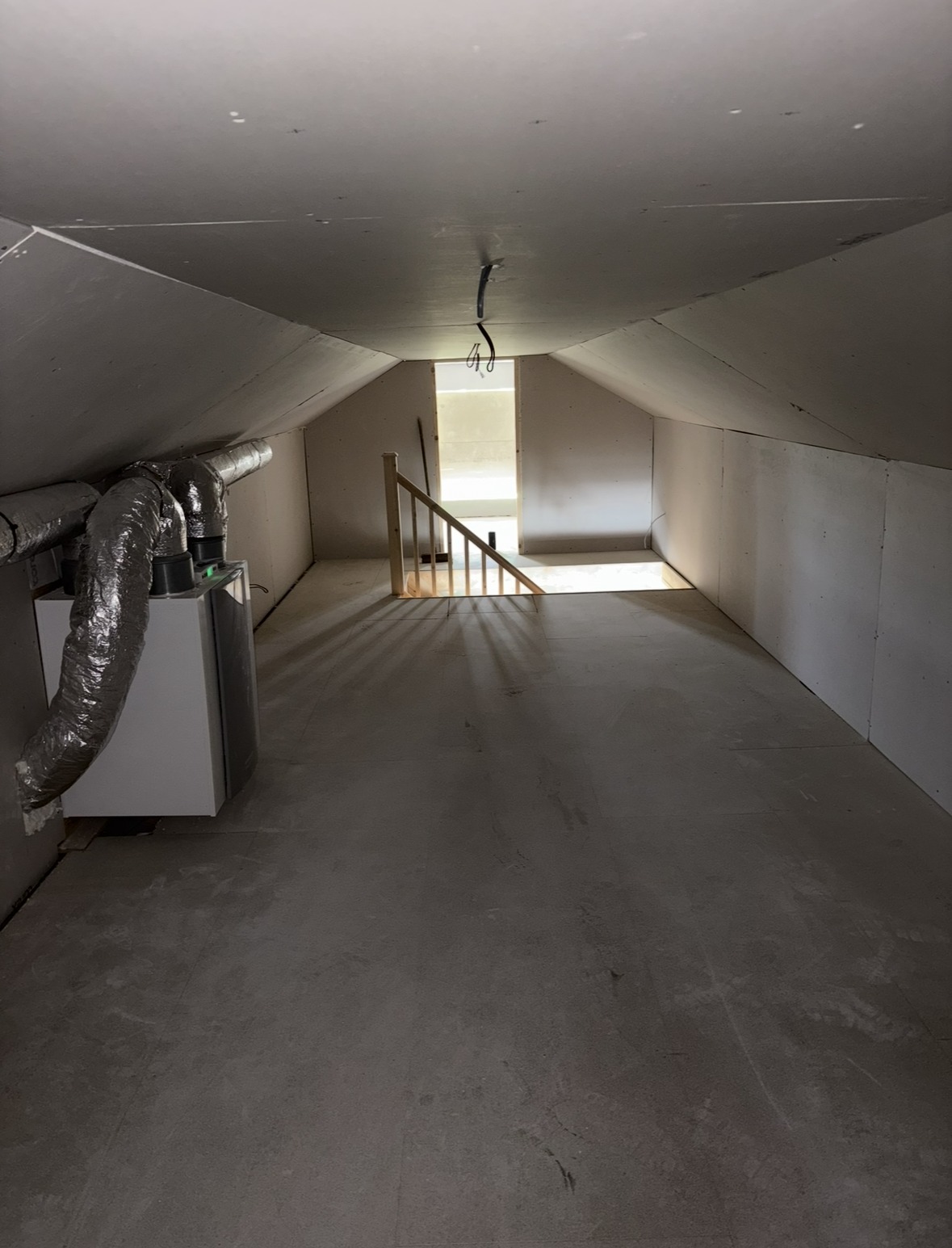 Completed loft conversion space with staircase access